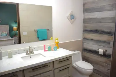 a bathroom with a sink and a toilet and a mirror at Casa Cocoa - 3 Br Home In Playa Langosta in Tamarindo