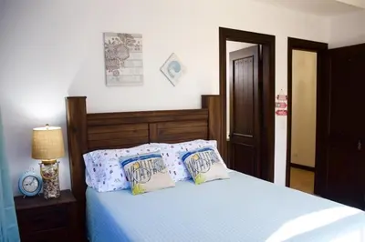 a bedroom with a bed with blue sheets and pillows at Casa Cocoa - 3 Br Home In Playa Langosta in Tamarindo