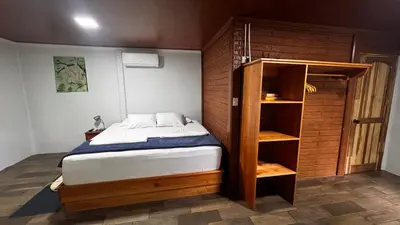 a bedroom with a bed and a book shelf at The frog house in Fortuna