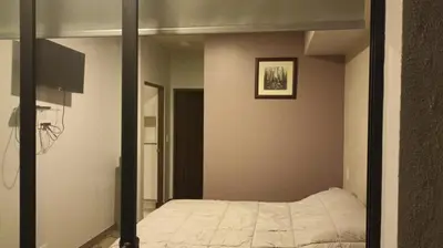 a mirror in a bedroom with a bed in it at Vurá 201 in San José