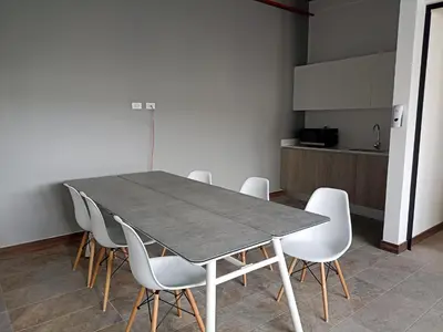 a dining room with a table and white chairs at Vurá 201 in San José