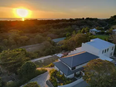 an aerial view of a house with the sunset in the background at Casa Ojos Azules, Nosara. New Listing in Nosara