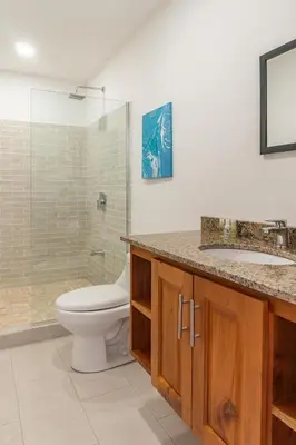 a bathroom with a toilet and a sink and a shower at Residencias Samara in Sámara