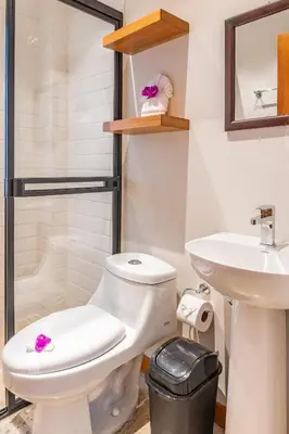 a bathroom with a toilet and a sink at Residencias Samara in Sámara