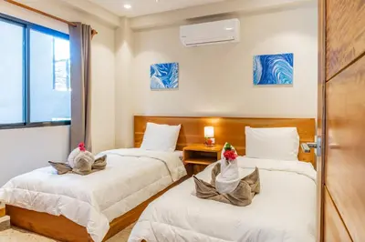 a room with two beds with towels on them at Residencias Samara in Sámara