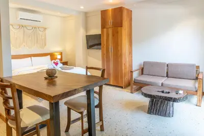 a living room with a table and a couch at Residencias Samara in Sámara
