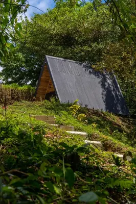a barn with a metal roof on top of a hill at Pozas y Cascadas La Presa Habitación 1 in Río Cuarto