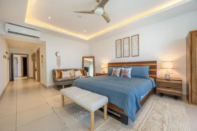 a large bedroom with a bed and a couch at La Vista 2 - Diriá Tamarindo in Tamarindo