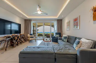 a living room with a couch and a tv at La Vista 2 - Diriá Tamarindo in Tamarindo