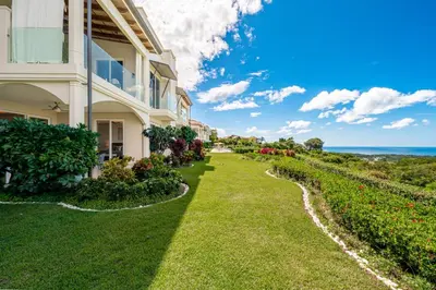 a building with the ocean in the background at La Vista 2 - Diriá Tamarindo in Tamarindo