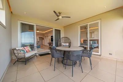 a dining room with a table and chairs at La Vista 2 - Diriá Tamarindo in Tamarindo