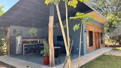a house with a tent with a table and a kitchen at Apartamento Entero El Guanacaste con Piscina Compartida in Santa Cruz