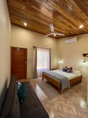 a bedroom with a bed and a wooden ceiling at Apartamento Entero El Guanacaste con Piscina Compartida in Santa Cruz