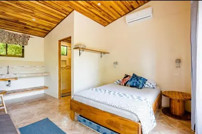 a bedroom with a bed and a wooden ceiling at Apartamento Entero El Guanacaste con Piscina Compartida in Santa Cruz