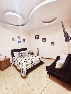 a bedroom with a bed and a couch at Apartamento SamSay I in Cartago