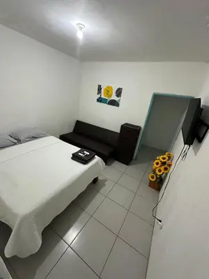 a small room with a bed and a couch at Tourquesa Excellent WiFi Private in Liberia