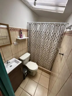 a bathroom with a toilet and a sink and a shower at Tourquesa Excellent WiFi Private in Liberia