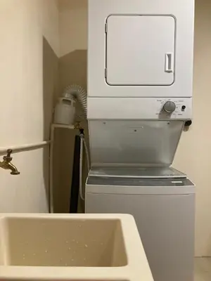 a microwave sitting on top of a refrigerator next to a sink at Hospedaje Ana Lu 2, Only 10 minutes from airport in Alajuela City