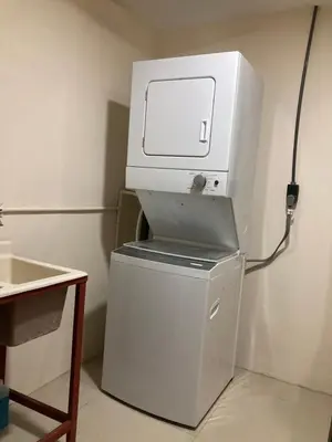 a white printer sitting on top of a refrigerator at Hospedaje Ana Lu 2, Only 10 minutes from airport in Alajuela City