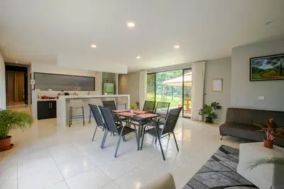 a dining room and living room with a table and chairs at River Paradise Villa With Private Jacuzzi in Fortuna