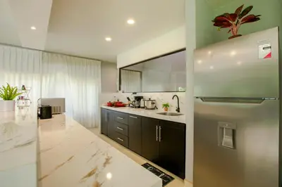 a kitchen with a refrigerator and a counter top at River Paradise Villa With Private Jacuzzi in Fortuna