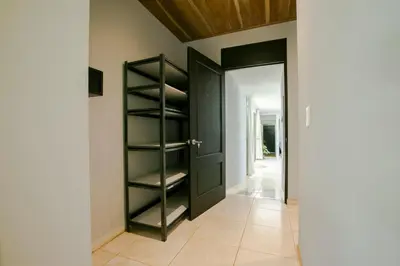 a hallway with a black door and a tile floor at River Paradise Villa With Private Jacuzzi in Fortuna