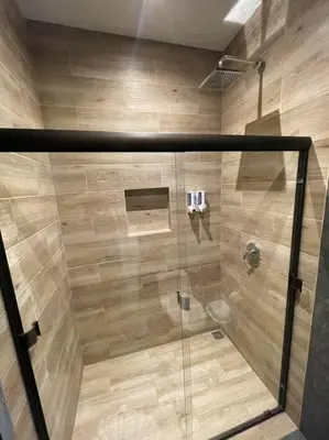 a shower with a glass door in a bathroom at River Paradise Villa With Private Jacuzzi in Fortuna