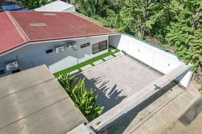 an overhead view of a house with a yard at Modern 4BR Home, Pool, Parking, Walk To The Beach in Playa Flamingo