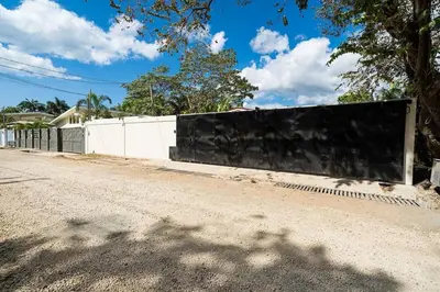 a fence on the side of a road at Modern 4BR Home, Pool, Parking, Walk To The Beach in Playa Flamingo
