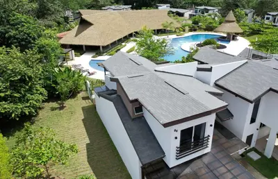 an aerial view of a house with a swimming pool at Casa Cardumen - Ciudad Del Mar, in Jaco in Jacó