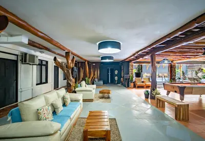 a living room with a couch and a pool table at La Flor de Coco in Sámara