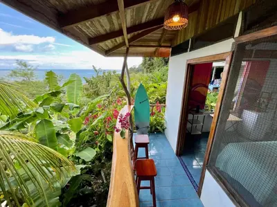 a porch of a house with a surfboard on it at The Chorotega Hotel, Montezuma in Montezuma