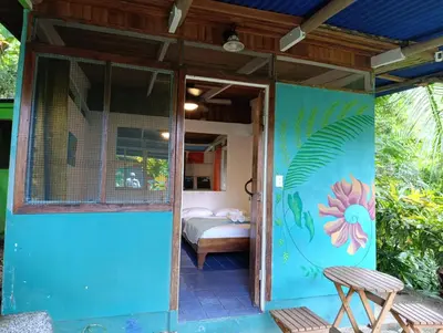 a room with a door and a bedroom with a bed at The Chorotega Hotel, Montezuma in Montezuma