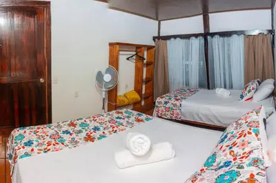 a hotel room with two beds and a fan at Tony´s House #2 in Fortuna
