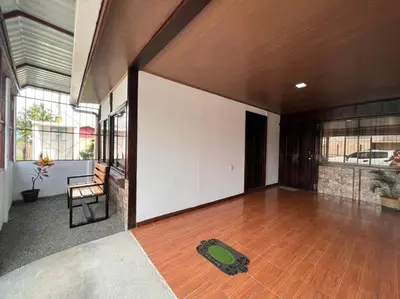a living room with a wooden floor and a chair at Tony´s House #2 in Fortuna