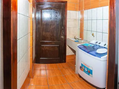 a bathroom with a toilet and a sink and a door at Tony´s House #2 in Fortuna