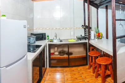 a kitchen with a sink and a refrigerator at Tony´s House #2 in Fortuna