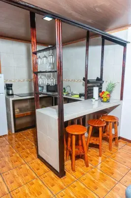 a kitchen with a counter and stools in a room at Tony´s House #2 in Fortuna