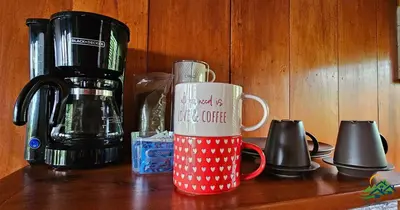 a red and white coffee mug sitting on a counter at Cabaña Colibrí in Quesada