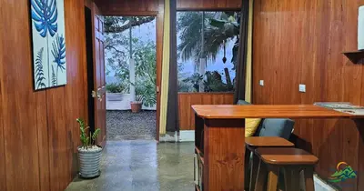 an office with a desk and a door to a yard at Cabaña Colibrí in Quesada