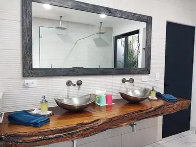 two sinks on a wooden counter in a bathroom at Playa Potrero - NEW modern house, pool in guitar shape - Casa Guitarra in Potrero