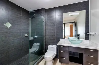 a bathroom with a toilet and a sink and a shower at Diamante del Sol 202N - 2nd Floor Ocean View in Jacó