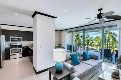 a living room with a couch and a kitchen at Diamante del Sol 202N - 2nd Floor Ocean View in Jacó