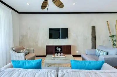 a living room with two couches and a tv at Diamante del Sol 202N - 2nd Floor Ocean View in Jacó
