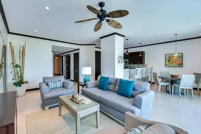 a living room with a couch and a ceiling fan at Diamante del Sol 202N - 2nd Floor Ocean View in Jacó