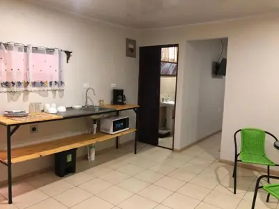 a kitchen with a sink and a table and chairs at Rivera Family Airport Apartments in Santiago Este