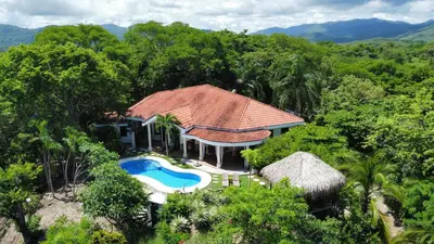 an aerial view of a house with a swimming pool at Villa Martina Palmgarden in Sámara