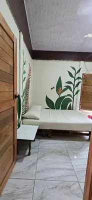 a room with two beds with plants on the wall at Boca Tapada Inn in Boca Tapada
