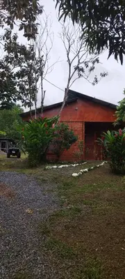 a red brick building with a tree in front of it at Boca Tapada Inn in Boca Tapada