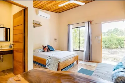 a bedroom with two beds and a window at Apartamento los Guanacastes cerca de Tamarindo con piscina in Santa Cruz